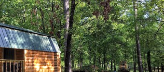 Small one room cabins with no bathrooms hot tub and covered picnic tables.