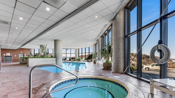 A pool area with a tiled deck, a lifebuoy, and a bench. - Sixth-Floor Condo w/ a Shared Hot Tub, Pool, Free WiFi, & an Electric Fireplace (Sugar Mountain)