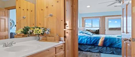 A bathroom with wooden cabinets, a sink, and a mirror.