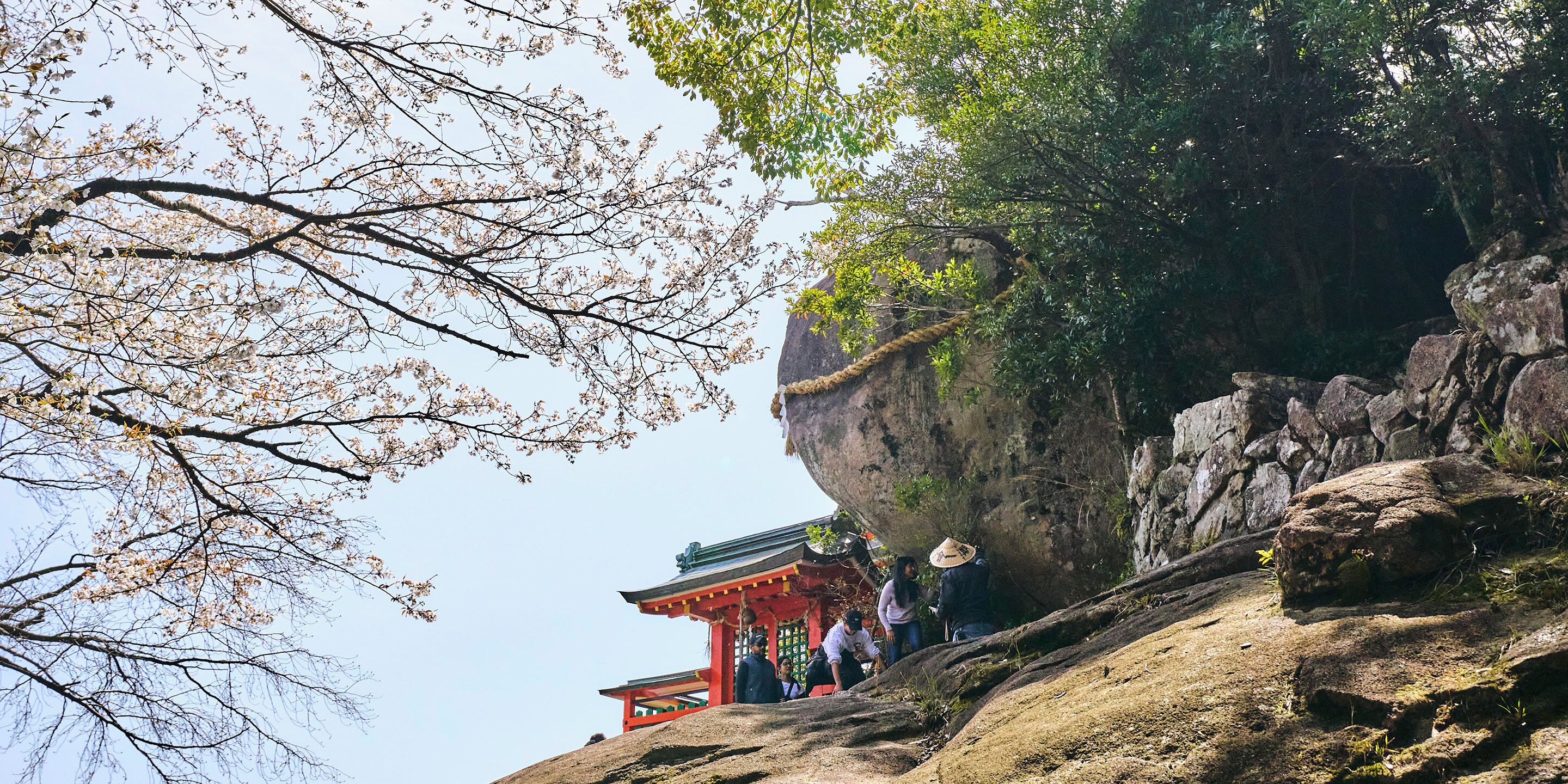 A traditional building with a red roof and a stone wall.