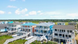 A coastal residential area with multi-story houses featuring balconies and waterfront access. - "Be Shell-Fish" Oceanfront, 6 Bedrooms, 4.5 Bathrooms (Supply)