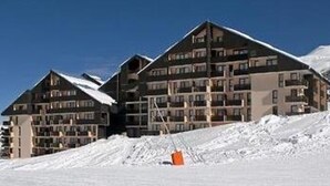 A multi-story hotel with a ski slope in the background. - Studio with Cabin at the Foot of the Slopes, Pets Allowed (Les Menuires)