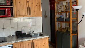 A kitchen with wooden cabinets, a microwave, a sink, and a small refrigerator. - Studio with Cabin at the Foot of the Slopes, Pets Allowed (Les Menuires)
