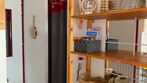 A wooden shelf with various items including a sign, baskets, and a decorative piece. - Studio with Cabin at the Foot of the Slopes, Pets Allowed (Les Menuires)