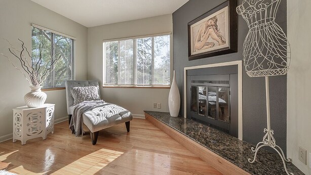 A bedroom with a bed, a fireplace, a window, and a decorative metal sculpture. - Spacious House with heated 24ft swim spa pool (Tampa)