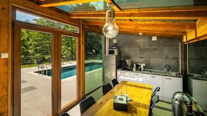 A modern kitchen with a stone backsplash, a built-in microwave, and a coffee maker.