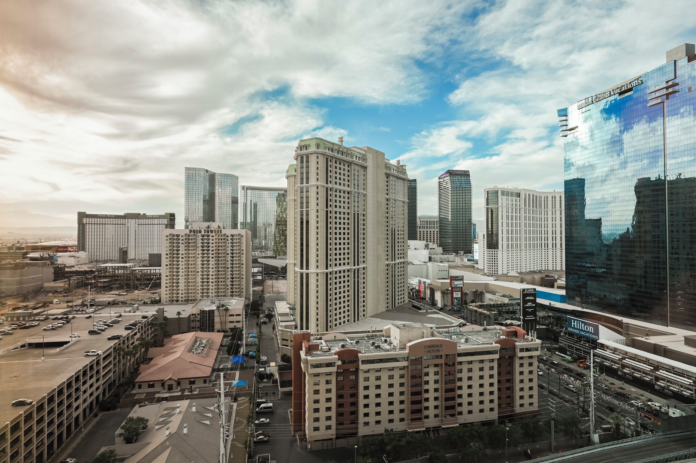 A cityscape with high-rise buildings, including a hotel with a visible sign.