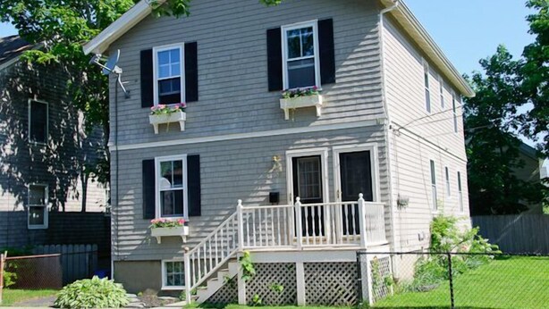 A two-story house with a front porch, a satellite dish, and flower boxes on the windows. - Atlantic Street Guesthouse - The Best Kept Secret! (Newport)