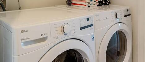 A laundry area with two white LG Direct Drive washing machines.