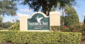 Southern Dunes Golf and Country Club sign features a stylized bird in flight against a green background.