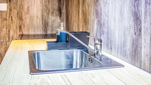 A modern kitchen with a stainless steel sink, a faucet, and a soap dispenser. - Awesome apartment in Gdansk with WiFi (Gdansk)