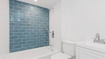 Bathtub, hair dryer, towels, soap