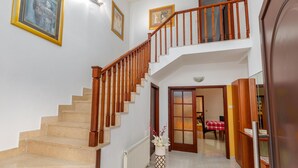 A staircase with wooden railings leading to a landing.