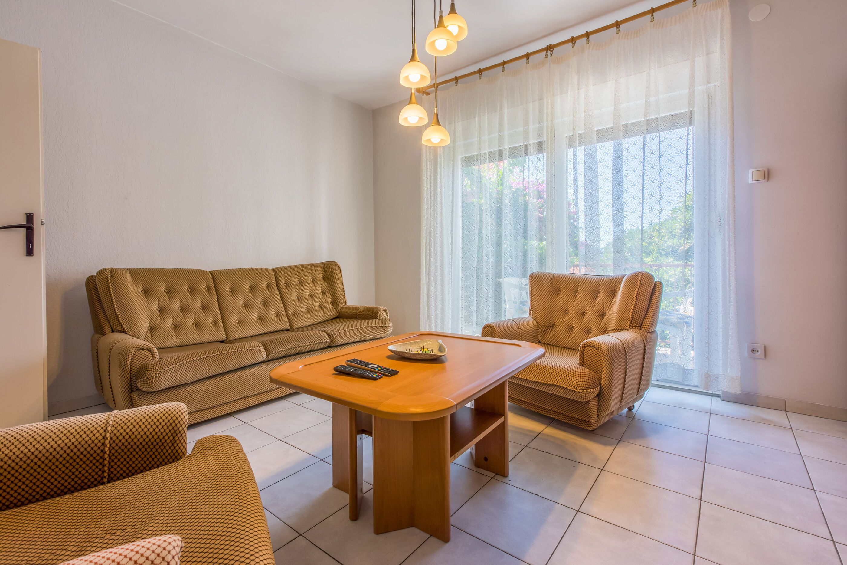 A living room with a sofa, armchair, and coffee table.