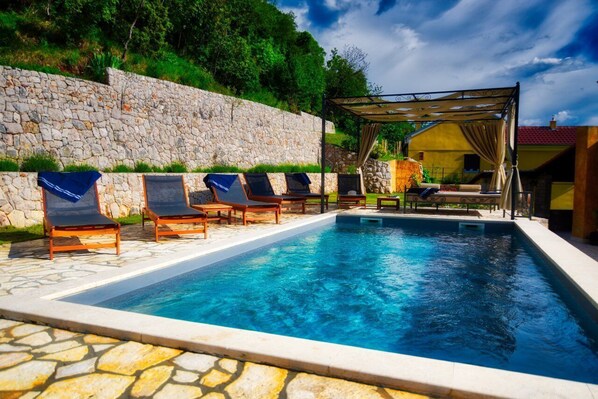 Outdoor pool, a heated pool, sun loungers