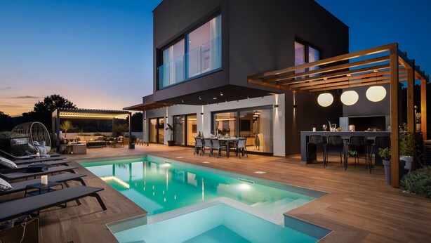 A modern two-story house with a swimming pool, outdoor seating, and a pergola. - Luxury Villa Indigo Kanica with Heated Pool (Dvornica)