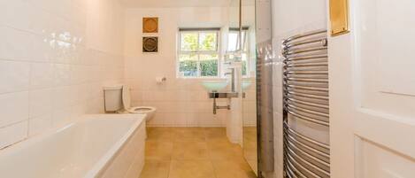 A modern bathroom with a bathtub, toilet, and sink.