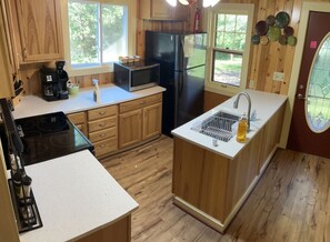 Microwave, coffee/tea maker, cookware/dishes/utensils, dining tables