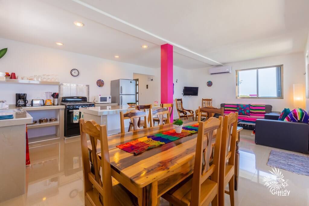 A modern apartment with a kitchen, dining area, and living room.