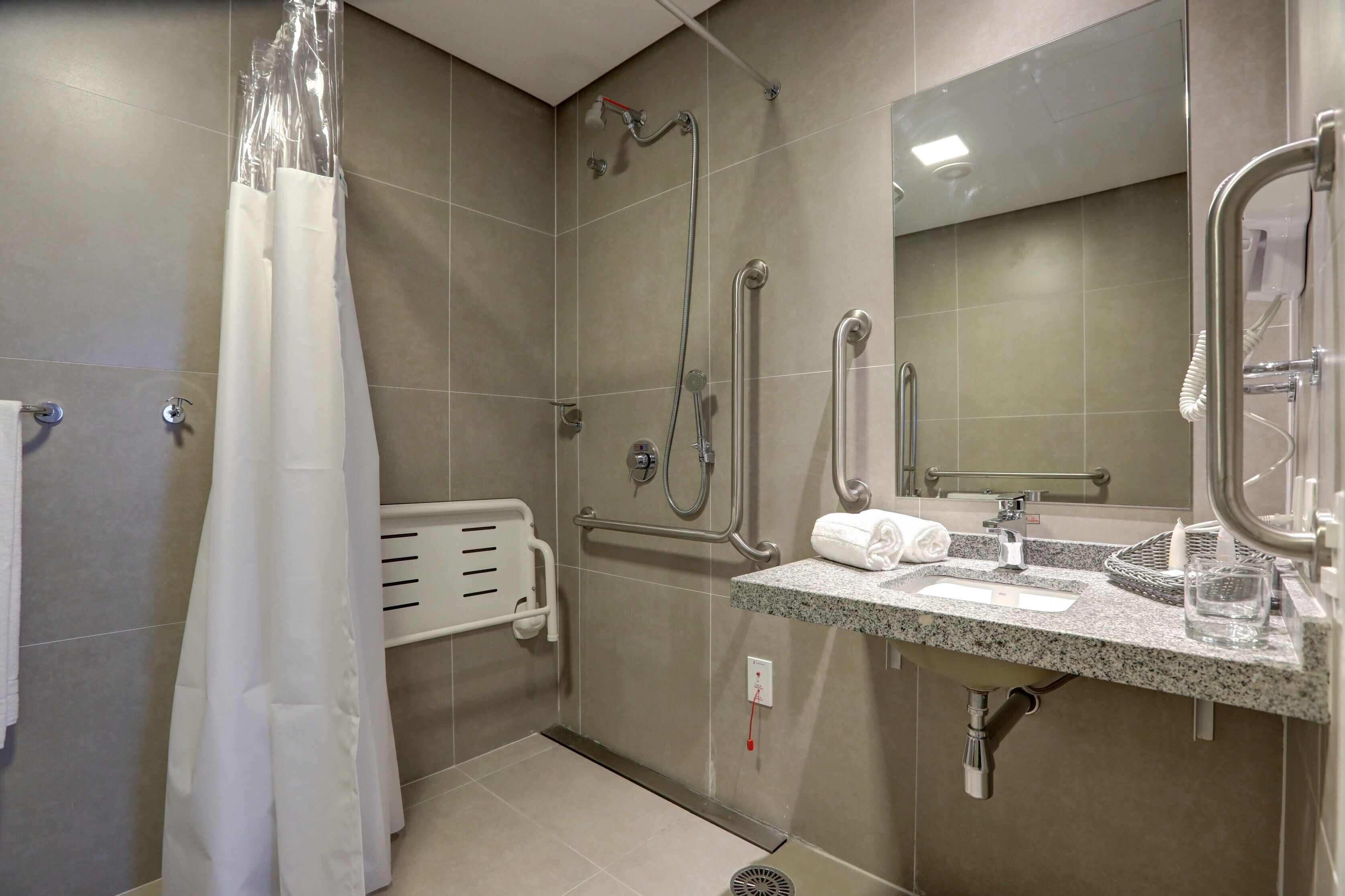 deluxe room | bathroom | shower, rainfall showerhead, hair dryer, bidet