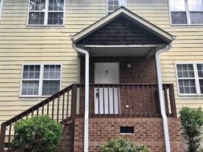 Stylish two-story home with a charming front porch and gabled roof.