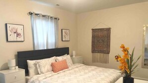 A bedroom with a bed, nightstands, a bedside table, a window with curtains, and a wall hanging. - ★Posh Place ★ King Bed ★ Long Term Stays ★ Duke★ (Durham)