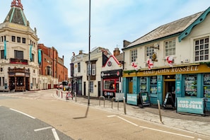 A street view with buildings including a theater, a pub, and a restaurant named 'Lord John Russell'.
