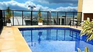 A rooftop pool with a clear view of the city skyline.
