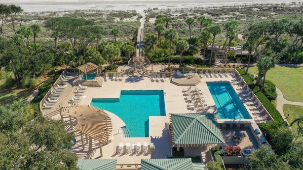 A resort with a large central pool, smaller side pools, and a beach view. - Family Villa | Ocean/Pool Views, Balcony, Bikes, Close to Shops/Dining (Hilton Head Island)