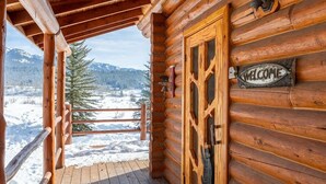 A wooden cabin with a wooden deck and a 'WELCOME' sign. - A Frame of Mind - Relax, Explore & Stay Together (Alpine)