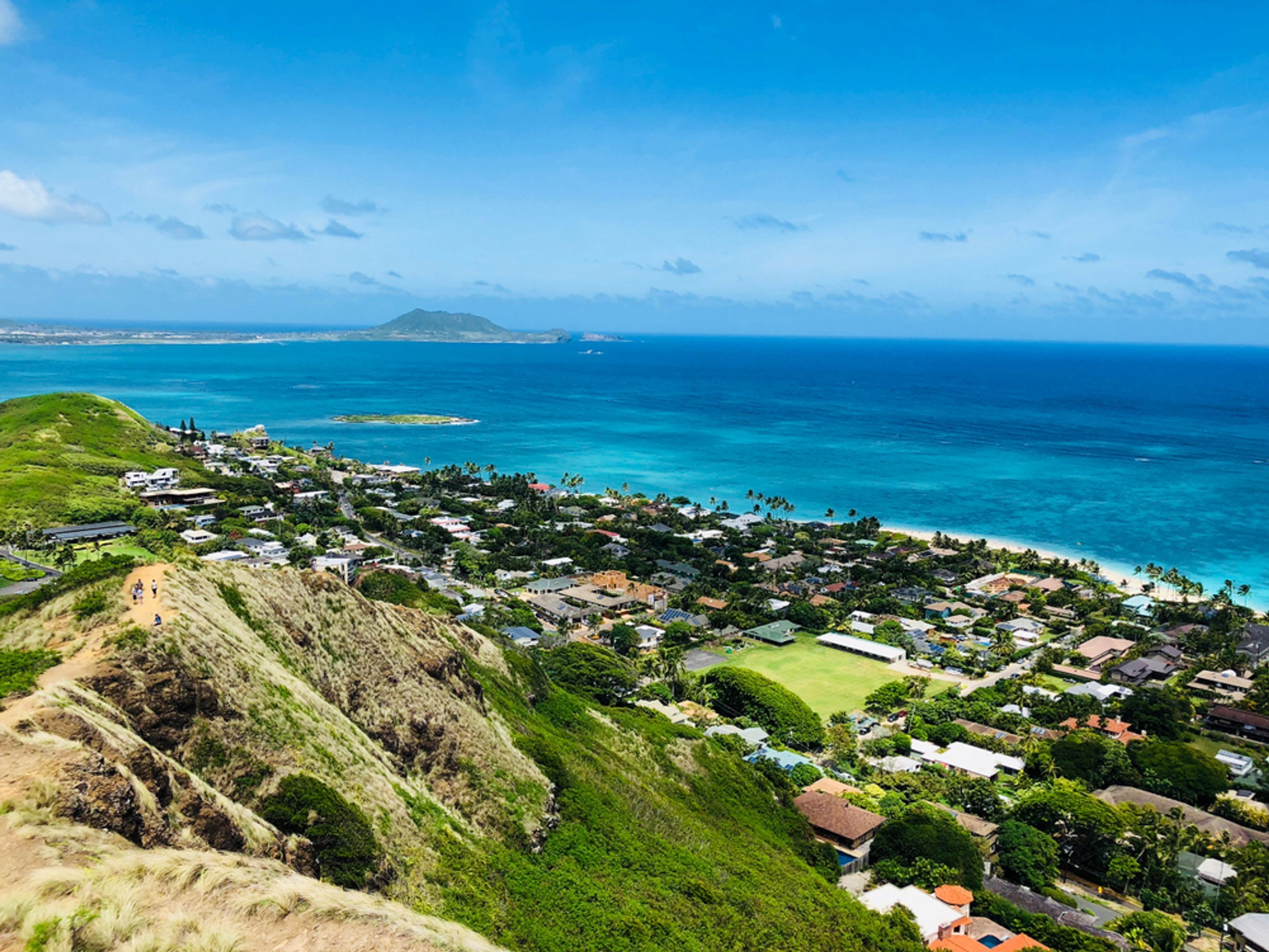 A coastal town with houses and a beach.
