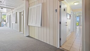 A corridor with doors, a white wall, and a ceiling with a light fixture. - Direct Oceanfront View - Beachfront Villa (Hilton Head Island)