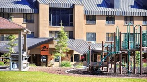 A hotel with a playground, a covered area, and a building with a sloped roof. - #1312 Winter and Summer Adventure Awaits! (Brian Head)