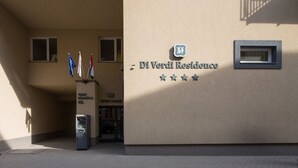A building entrance with a sign reading "Di Verdi Residence" and flags. - Di Verdi Imperial Hotel (Budapest)