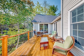 Relax on the deck with a wicker chair and enjoy the serene surroundings.