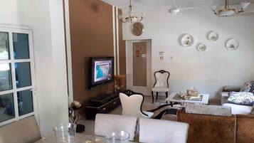 Executive Villa | Living area | 50-inch TV with cable channels