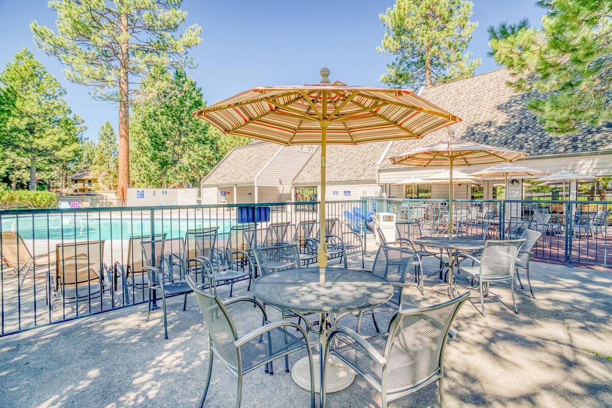 A poolside area with outdoor seating and umbrellas.