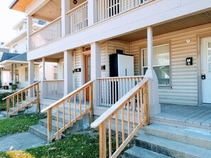 Steps lead up to the porch, where multiple doors offer access to the building.