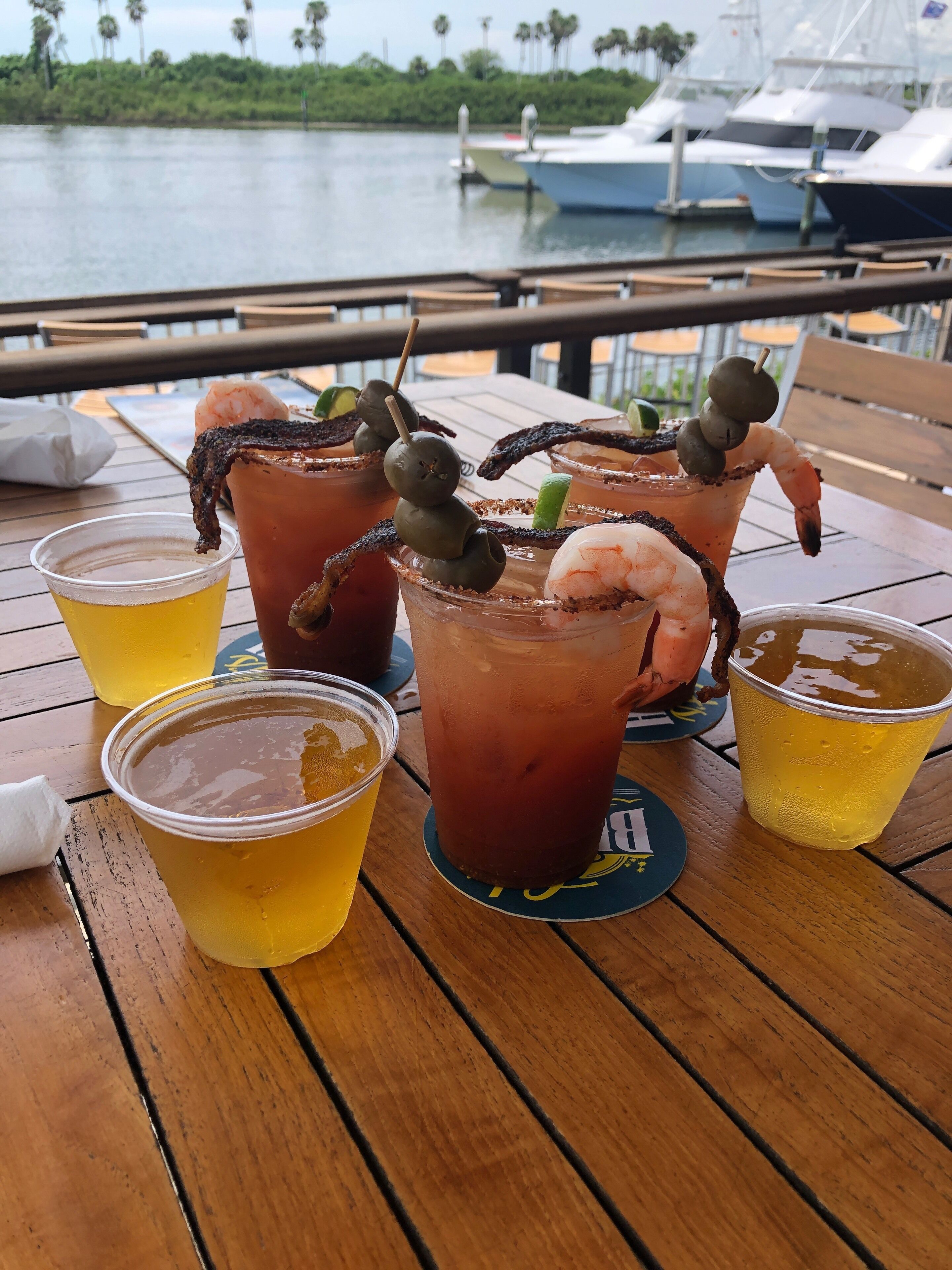 A table with drinks, including cocktails with garnishes and a clear beverage.