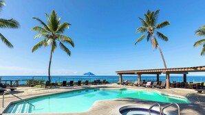A pool area with lounge chairs and a view of the ocean. - Kanaloa At Kona Enjoy Peace in Paradise! (Kailua-Kona)
