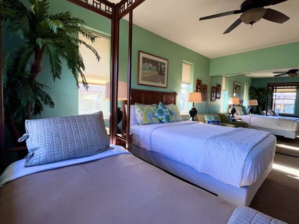 A room with two beds, a ceiling fan, and a large potted plant. - Hali'i Kai 15A at the Waikoloa Beach Resort (Waikoloa)