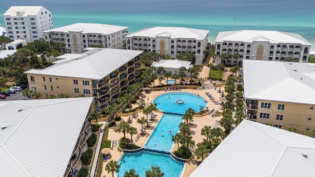 A resort with multiple buildings, a central swimming pool, and a view of the ocean. - Resort Style Community - Private Beach Access (Santa Rosa Beach)