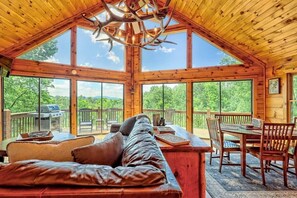 A spacious cabin with a high ceiling, large windows, a wooden dining area, and a cozy seating area. - Hot Tub, 3 Fireplaces, Mountain Views, Game Room (Blue Ridge)