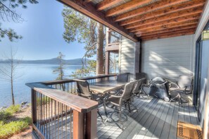 A deck with a table and chairs overlooking a lake. - Brockway Springs Lodge Steps to Lake Access! (Kings Beach)