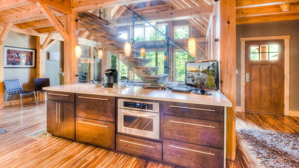 A spacious kitchen with a large island, wooden beams, and a view of the outdoors. - Shining Shire - Sauna, Steam Shower, Very Cool! (South Lake Tahoe)