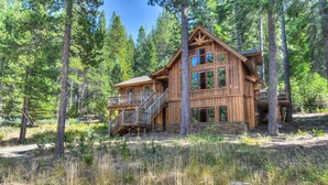 A wooden cabin with a balcony and a staircase, surrounded by trees. - Shining Shire - Sauna, Steam Shower, Very Cool! (South Lake Tahoe)