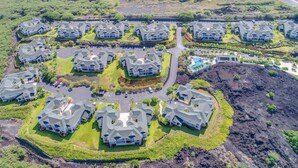 A residential area with multiple houses, each with a unique roof design, surrounded by greenery and a central road. - Luxury at Na Hale O Keauhou #N1 (Kailua-Kona)