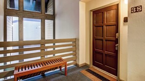 A wooden bench and a door with the number 38 on it.