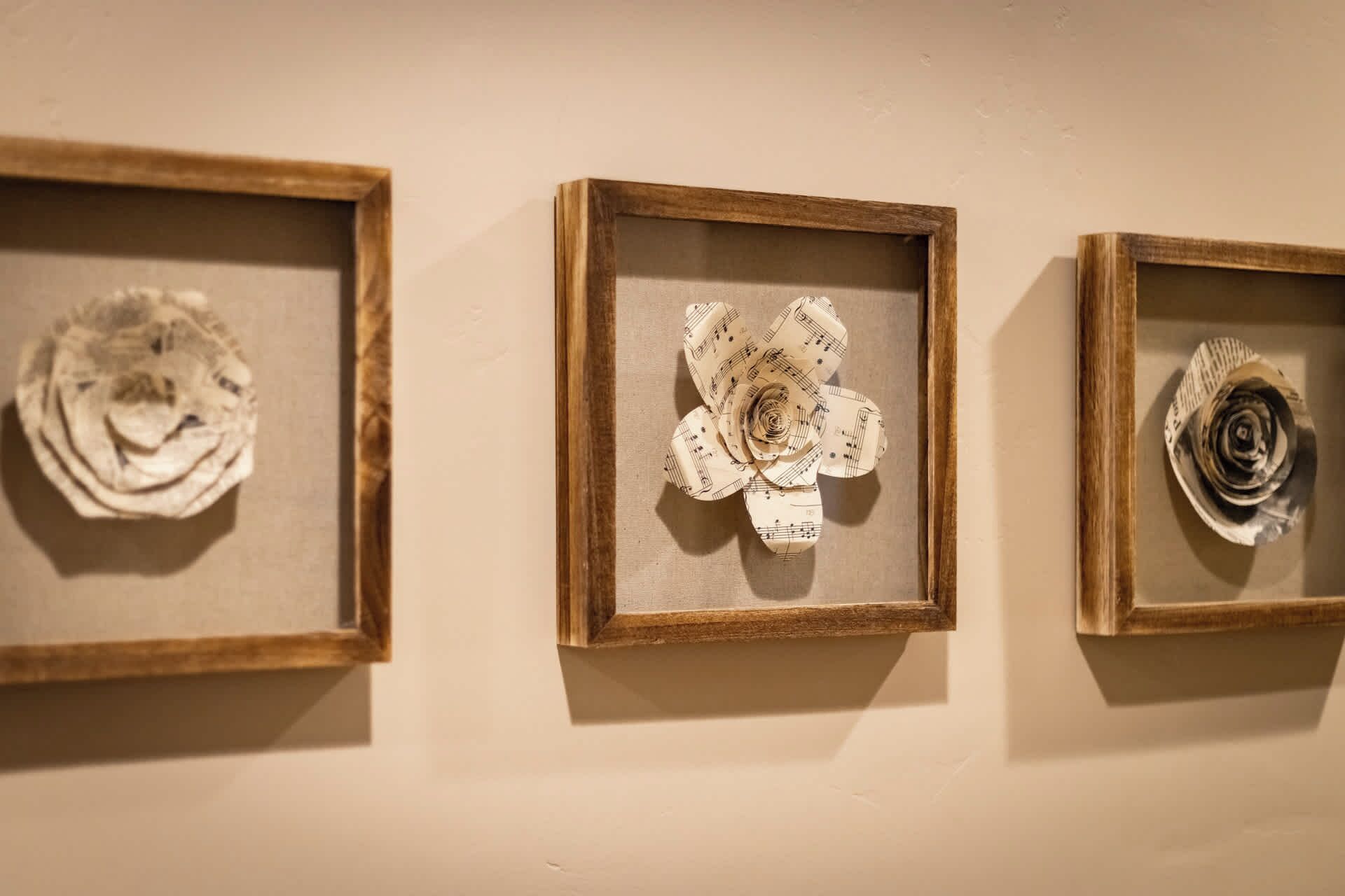 Three framed artworks on a wall.