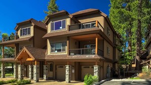 A multi-story residential building with a stone facade, multiple balconies, and a garage entrance. - Tahoe Woods Villa - Walk to Beach and Gondola/ Heavenly Ski (South Lake Tahoe)